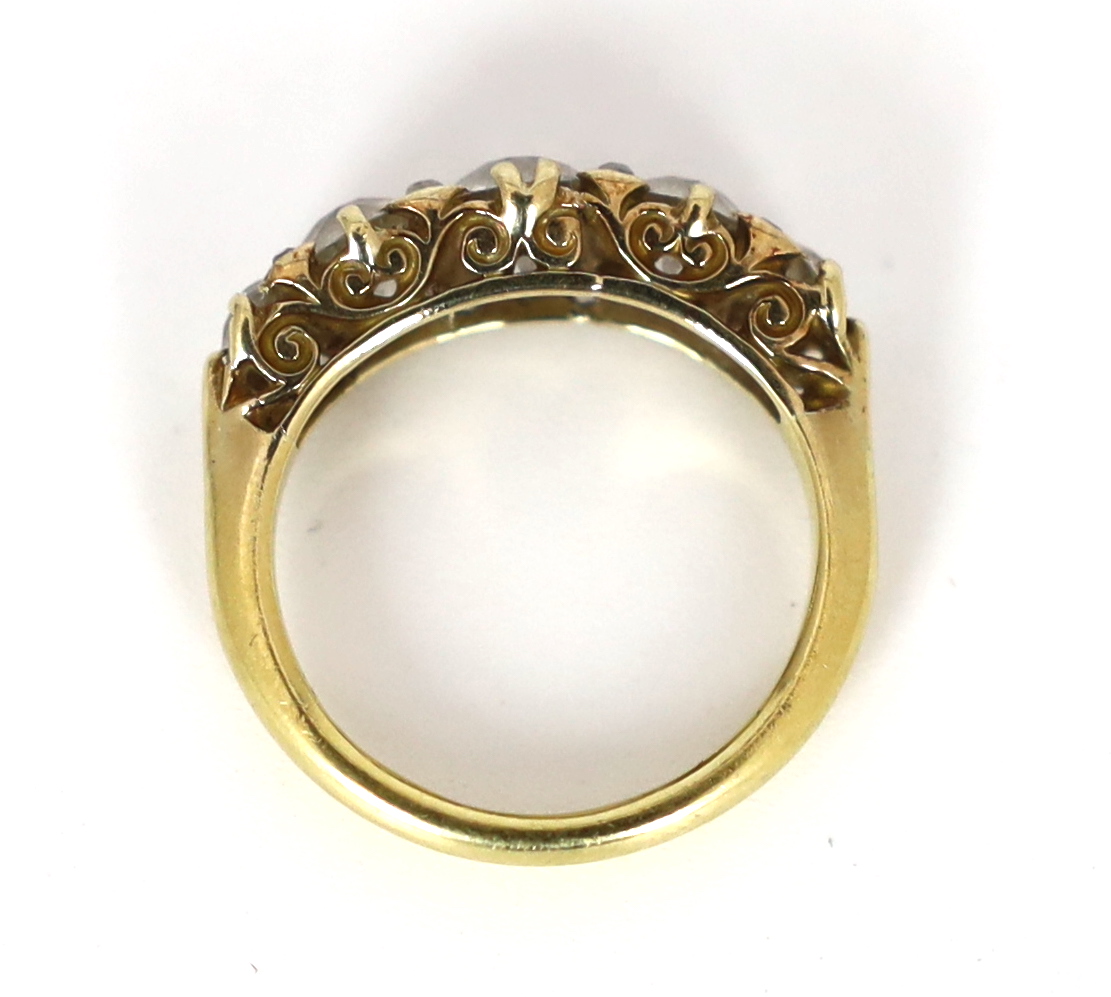 An early 20th century 18ct gold and graduated old round cut diamond set half hoop ring